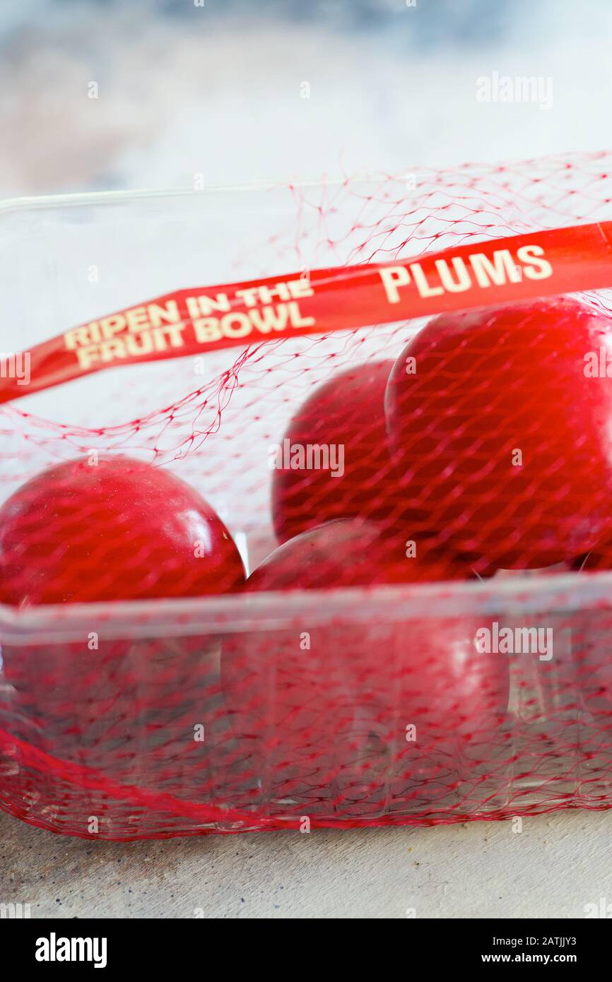 Red Plums Ripen in the Bowl Stock Photo