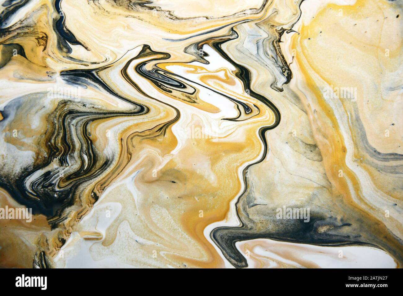 Acrylic paint fluid in trend black and gold with yellow color mix  background Stock Photo - Alamy