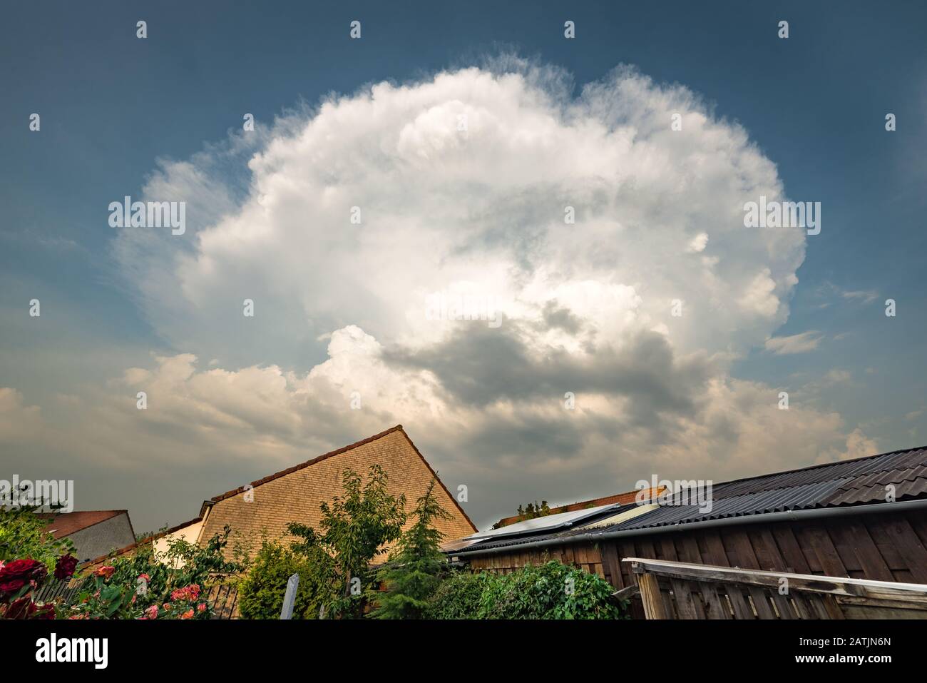 Explosive thunderstorm viewed from a city garden Stock Photo