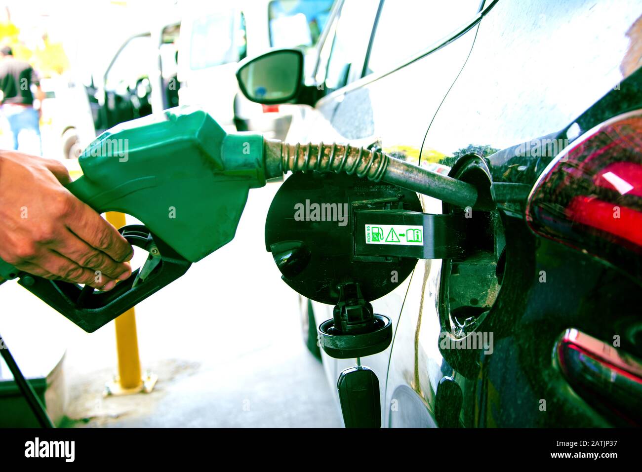 Hand holding gasoline pomp Stock Photo