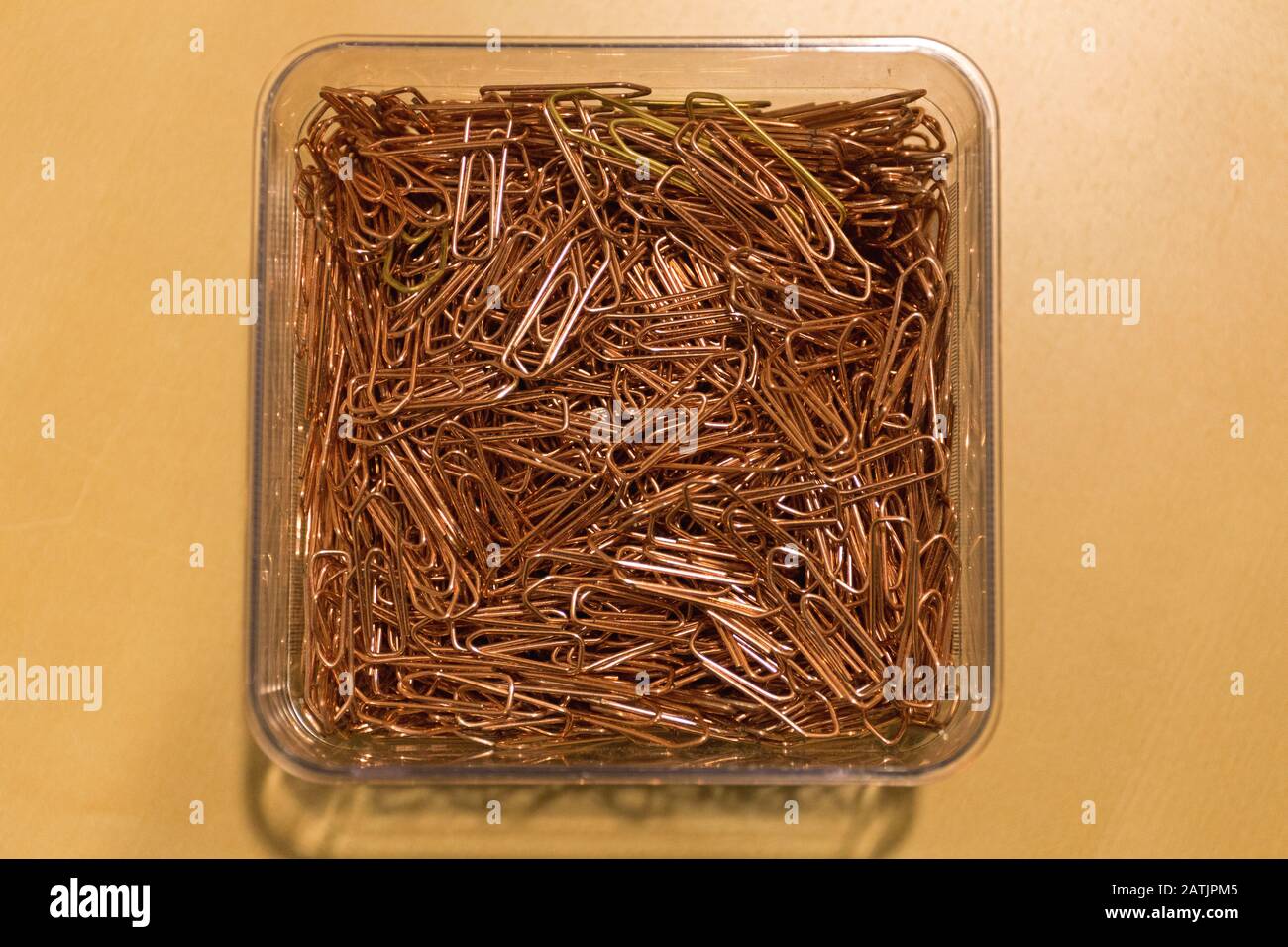 Bunch of Paper Clips in Box at Desk Stock Photo