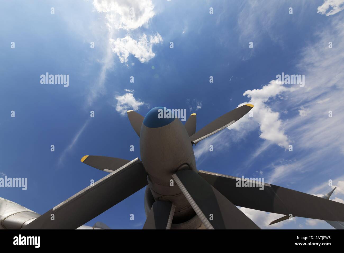 Propeller blade of engine. Part of airplane and sunlit blue sky with ...