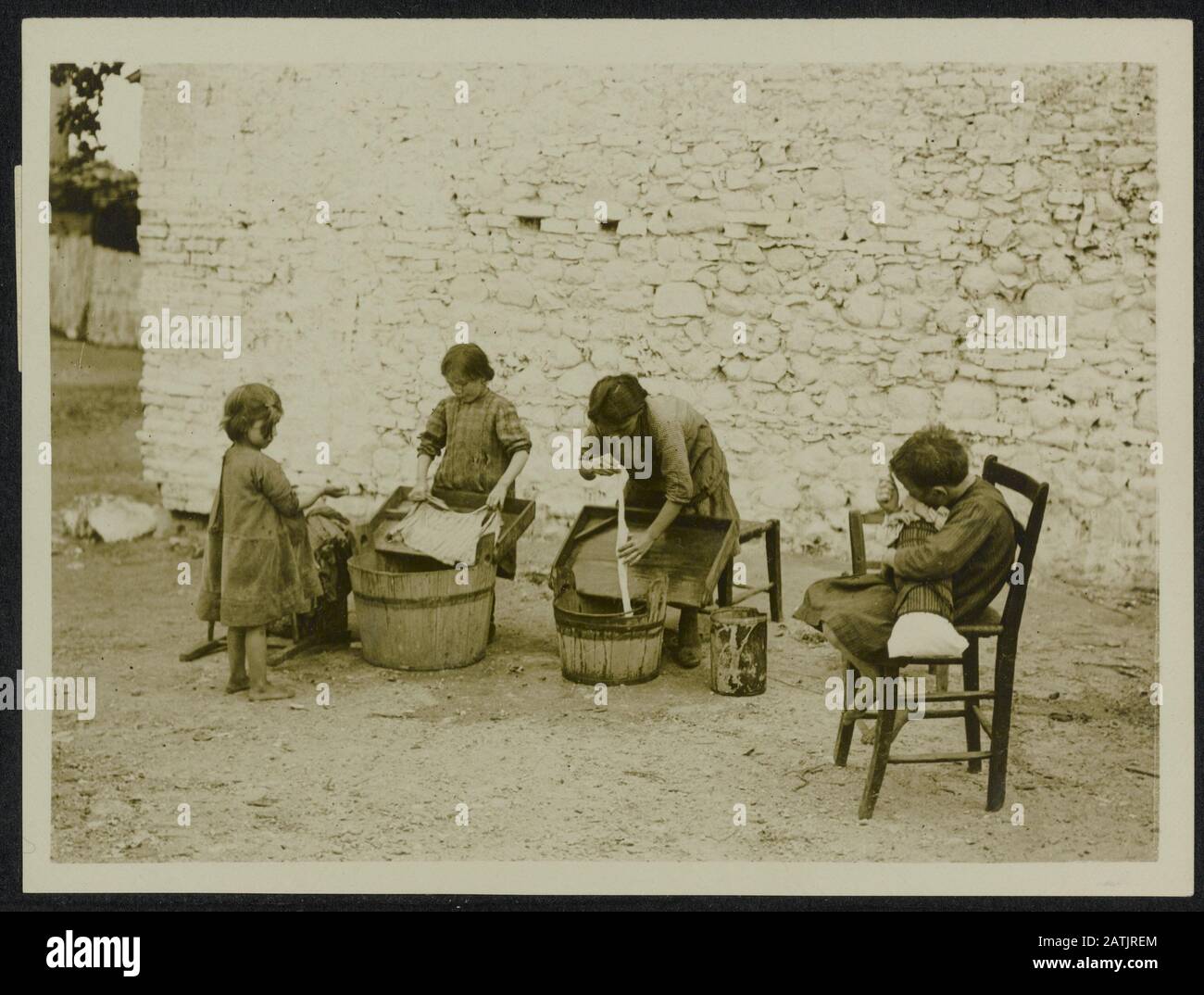 British official photographs from Italy Description: While Their fathers are at the war and Their mothers in the field, Italian children do the washing. Annotation: British official photos from Italy. While their fathers are participating in the war and their mothers to the country, the children do the laundry. Date: {1914-1918} Location: Italy Keywords: WWI, children, washing Stock Photo