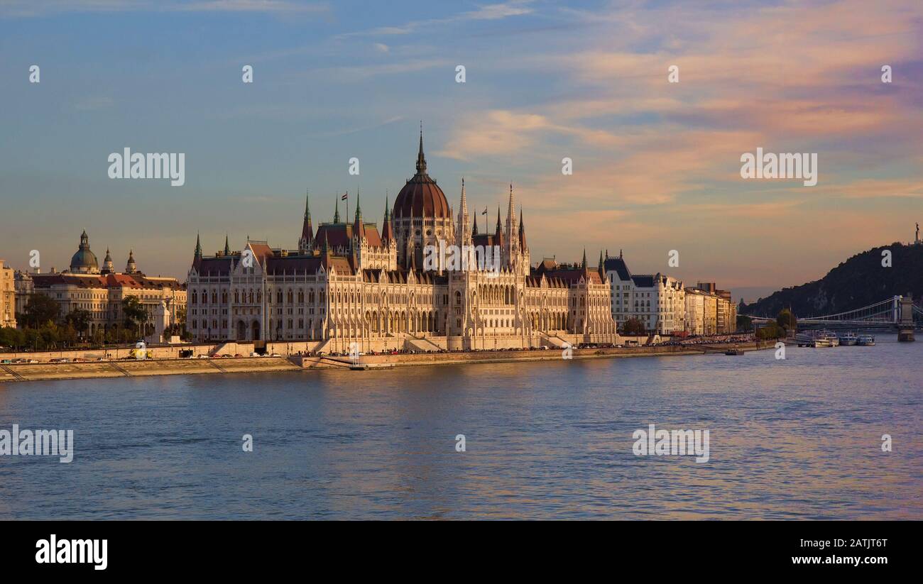 Neo-gothic Hungarian Parliament Building in the Pest side of Budapest and on the banks of River Danube at sunset. Stock Photo
