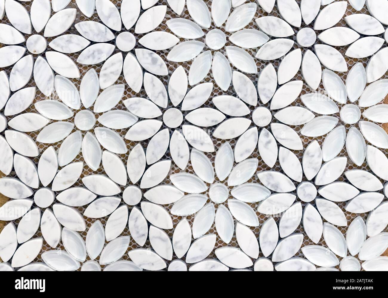 Marble tiles mosaic in the shape of flowers. Background of white marble