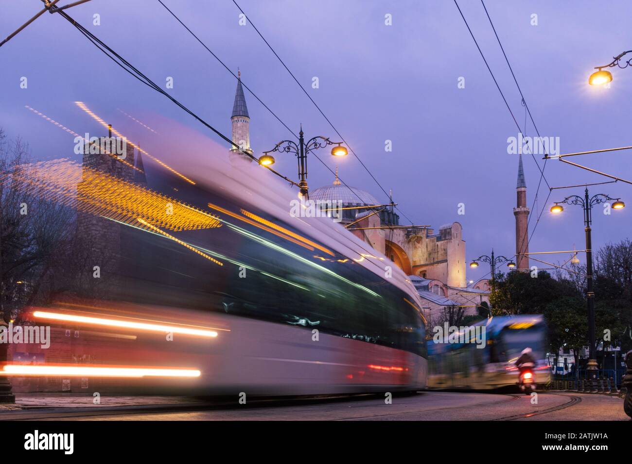 Istanbul, Turkey - Jan 9, 2020: A T1 tram passes the Hagia Sophia museum at dusk, Istanbul, Turkey Stock Photo