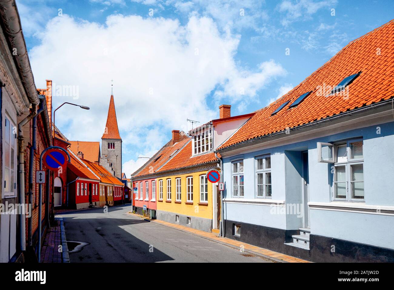 Streets of a small danish village with red rooftops in the summer sun under a blue sky Stock Photo