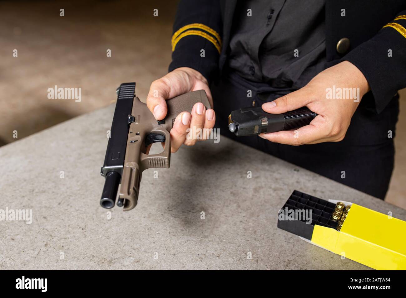 Two hand reloading law enforcement pistol in academy shooting range