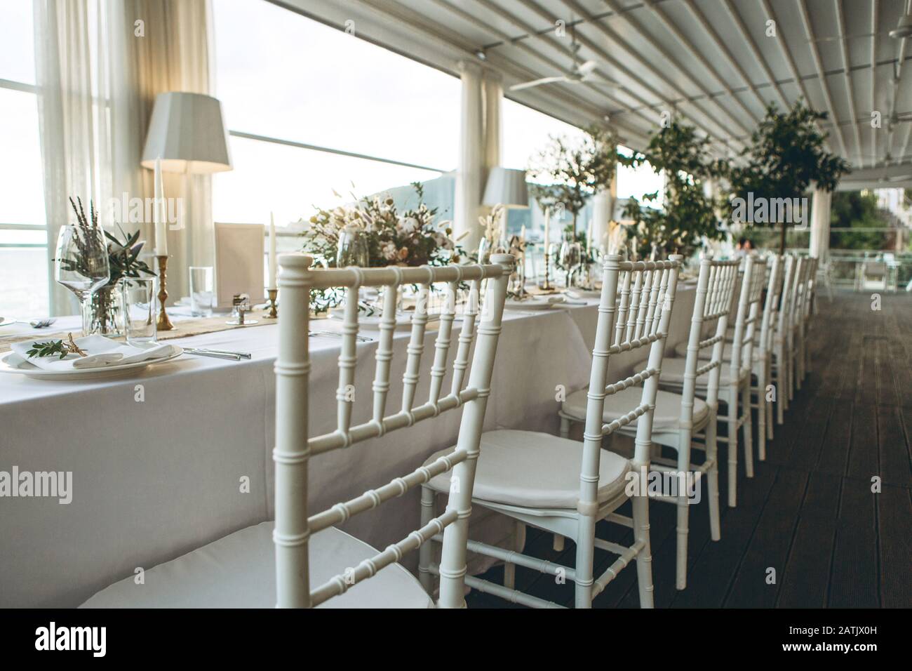 Chairs in a row. Table setting and decoration for a ceremony or ...