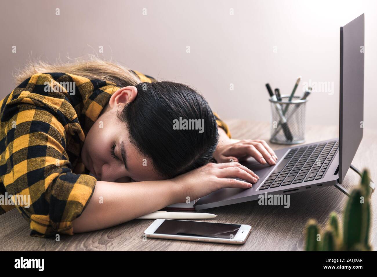 tired business woman, freelancer or student falls asleep on working desk. No more energy Stock Photo
