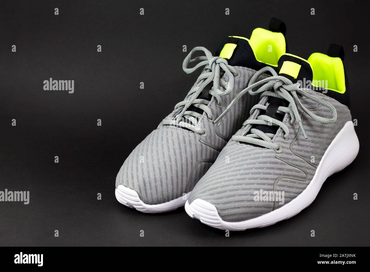 Shop display of new sneakers running shoes for men isolated on the black background. Stock Photo