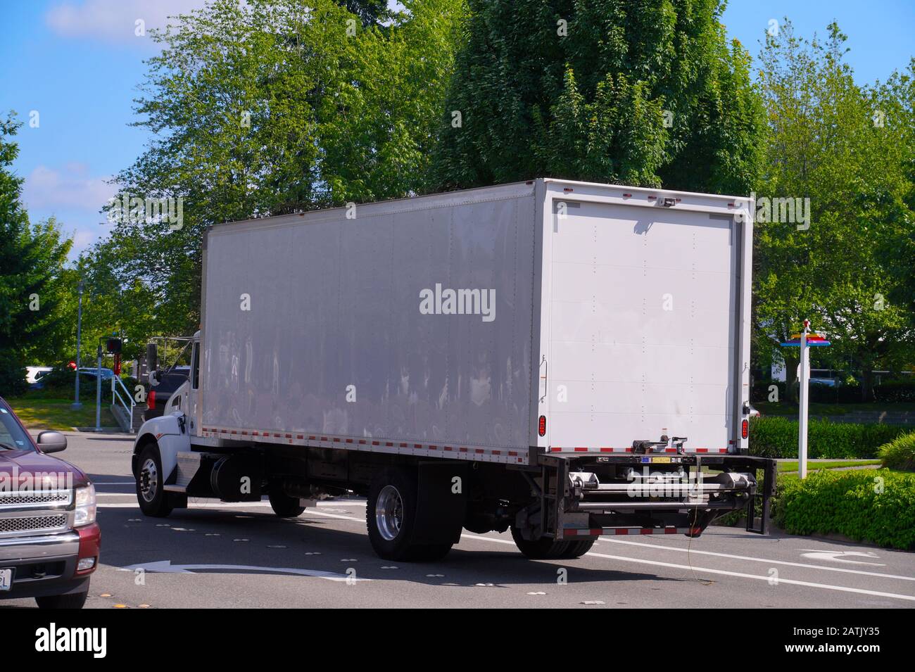 A medium-sized truck while driving. Delivery of goods in the city. Stock Photo