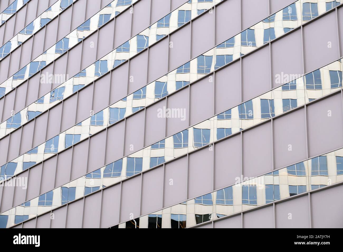 Reflection in the facade of another building. The facade of a modern building. Stock Photo