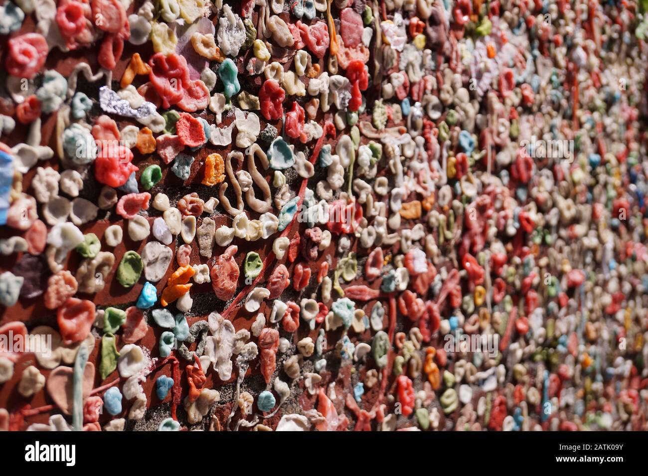 Gum wall. Chewing gums stuck to the wall. One of the tourist attractions  in Post Alley in Downtown Seattle. Stock Photo