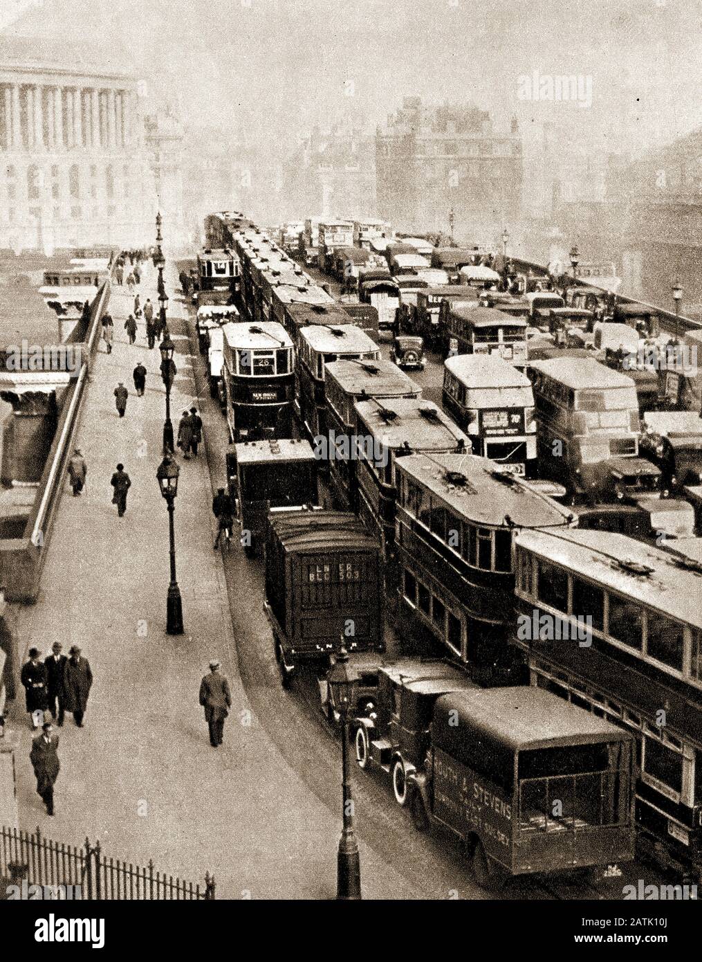 1935 Traffic Jam on Blackfriars Bridge , London, showing a snarl-up of buses,trams,trucks, cars and other motor vehicles. The was opened by Queen Victoria on the  6th November 1869. The 4 arch wrought iron bridge  is 923 feet (281 m) long,was designed by Joseph Cubitt who also designed the now demolished adjacent rail bridge. Stock Photo