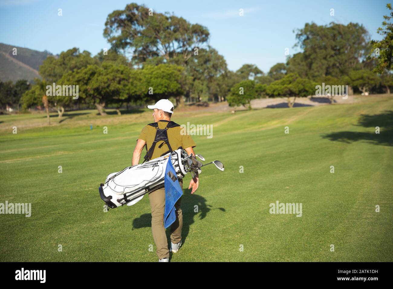 Golfer walking with golf bag Stock Photo Alamy