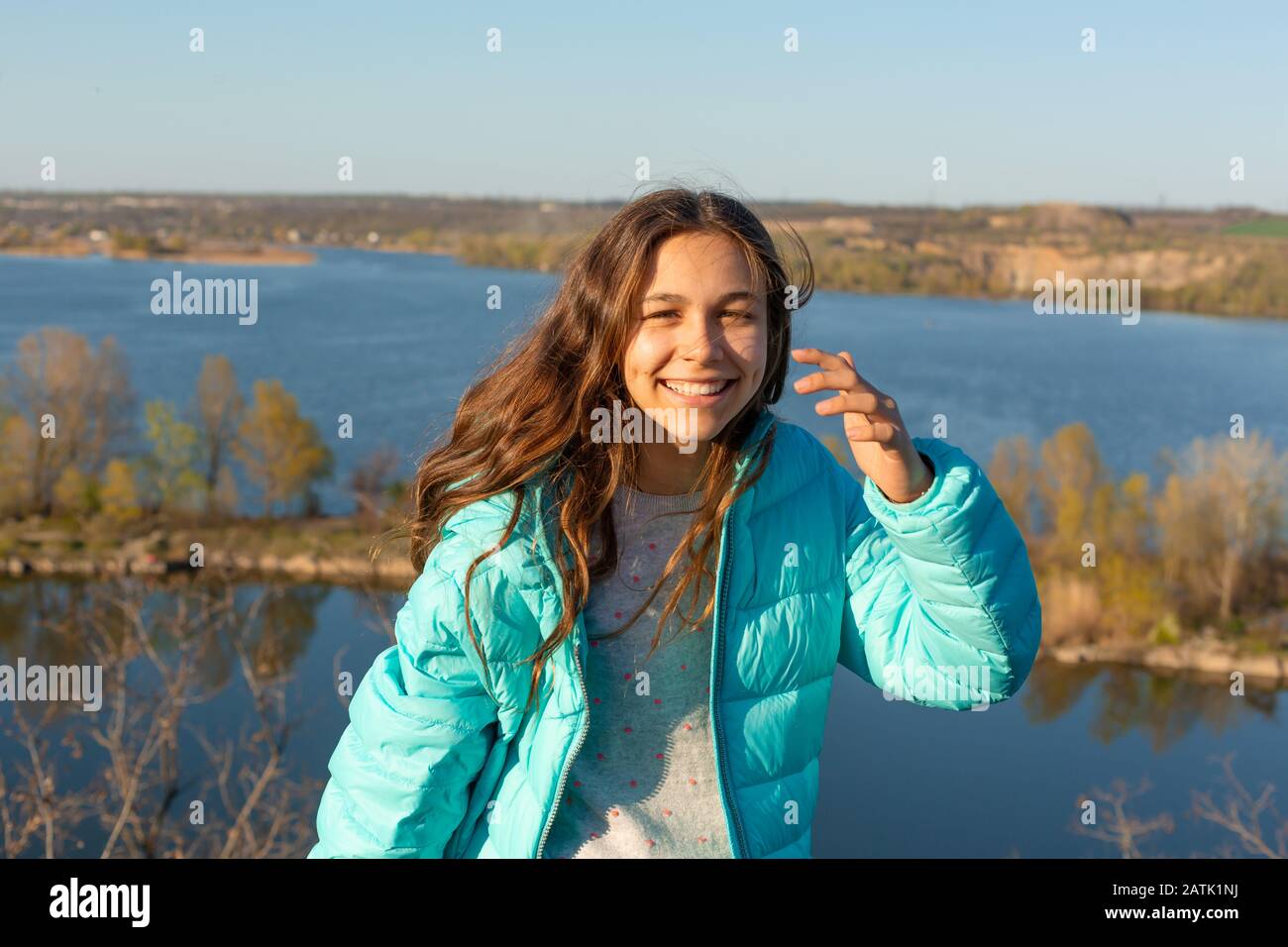 Portrait of a beautiful smiling teen girl on a lake background Stock ...