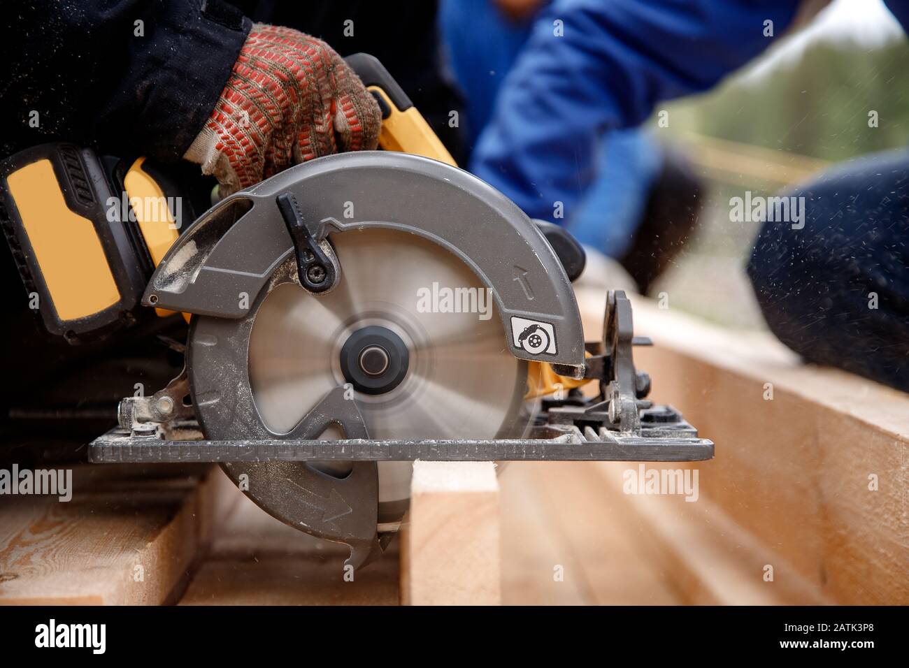 Builder uses portable circular saw tool to cut wood Stock Photo Alamy