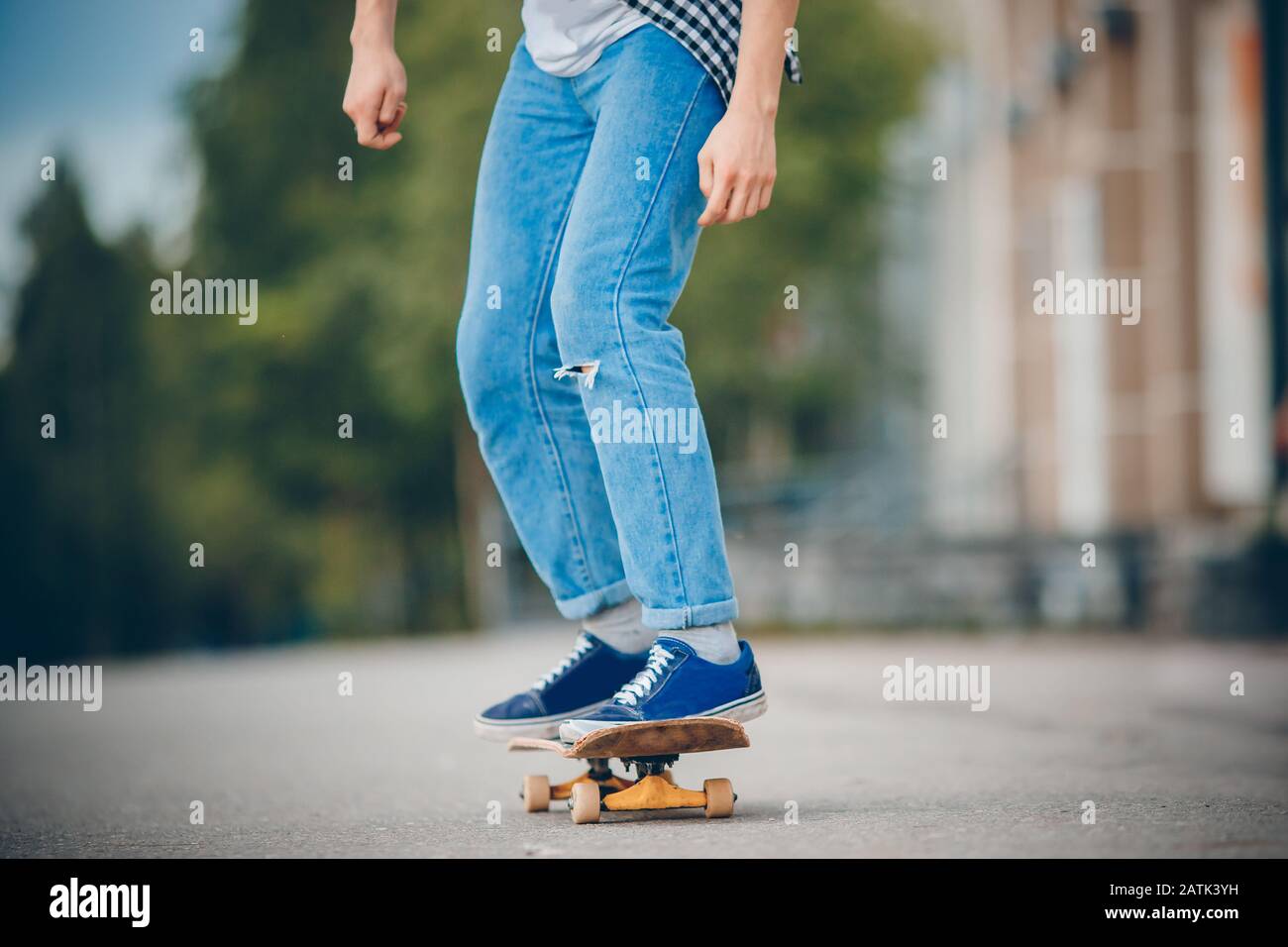 Skateboard man practices to ride on asphalt, learns tricks Stock Photo