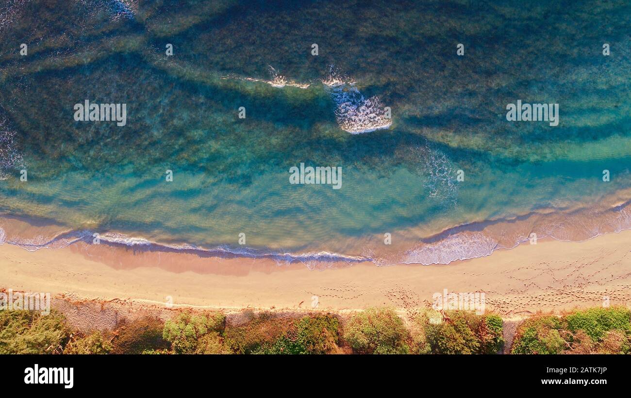 Aerial view down onto Laie Beach Park (Pounders) with calm turquoise