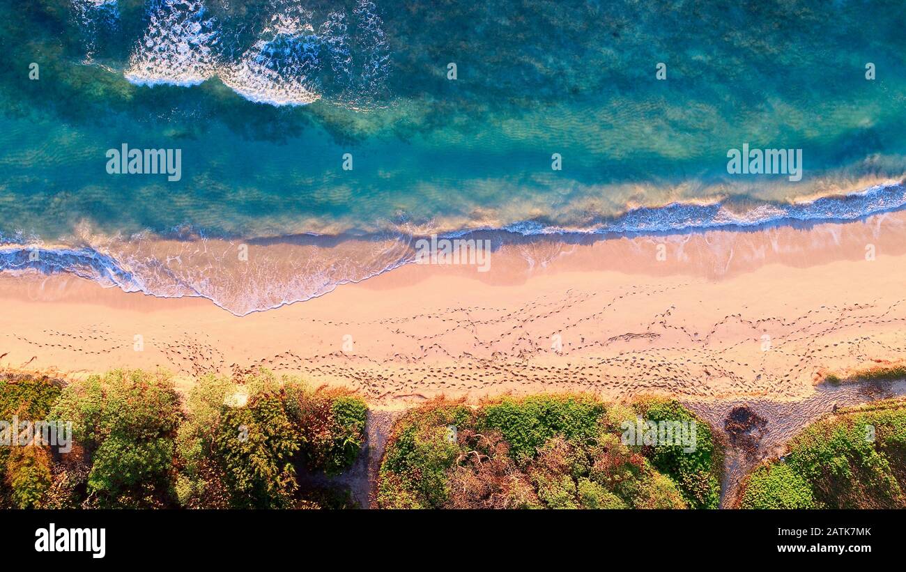 Aerial view down onto Laie Beach Park (Pounders) with calm turquoise