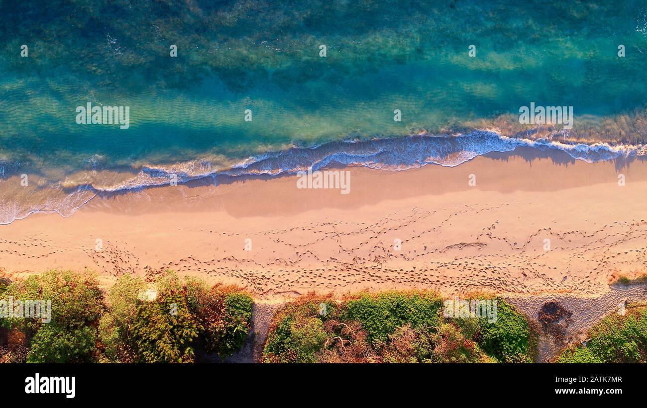 Aerial view down onto Laie Beach Park (Pounders) with calm turquoise
