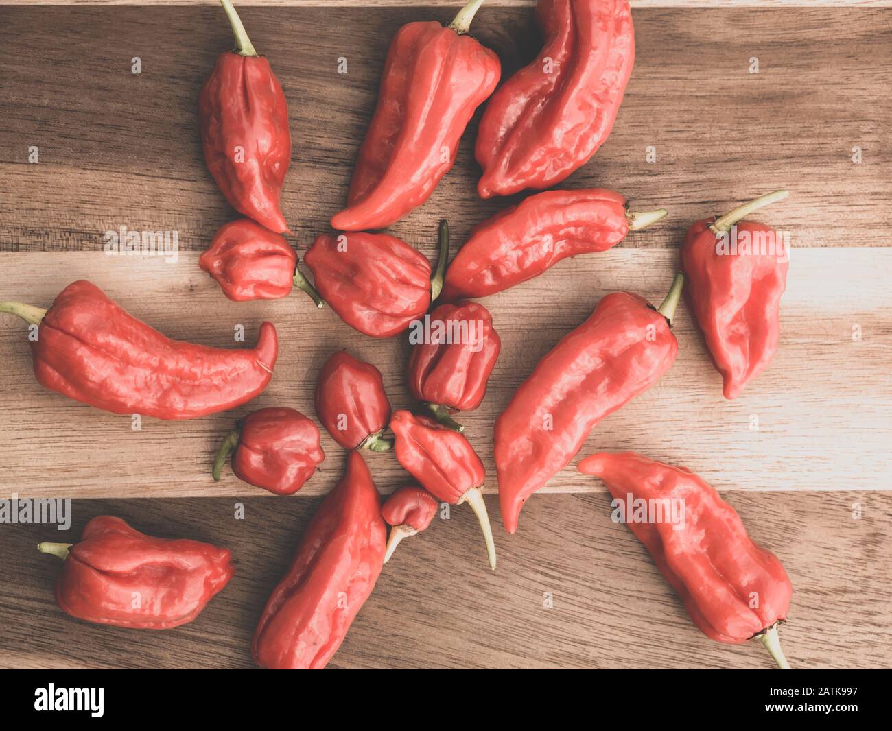 Bunch of red Bhut Jolokia chili on wooden background Stock Photo