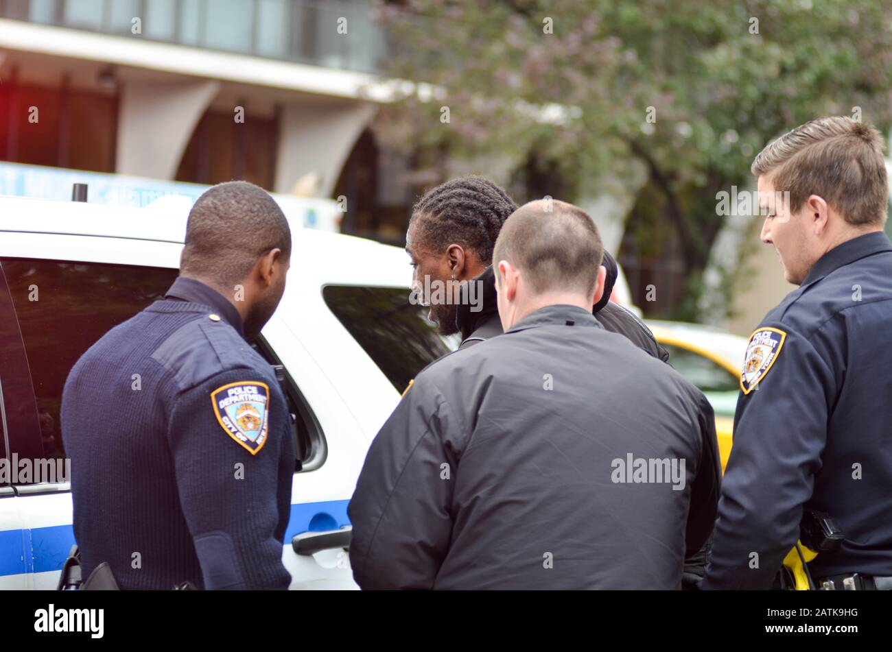 NYPD officers are seen arresting a bike messenger for unknown reasons at the 7th Avenue and 59th street (Central Park) in New York City on Oct 8,2018. Stock Photo