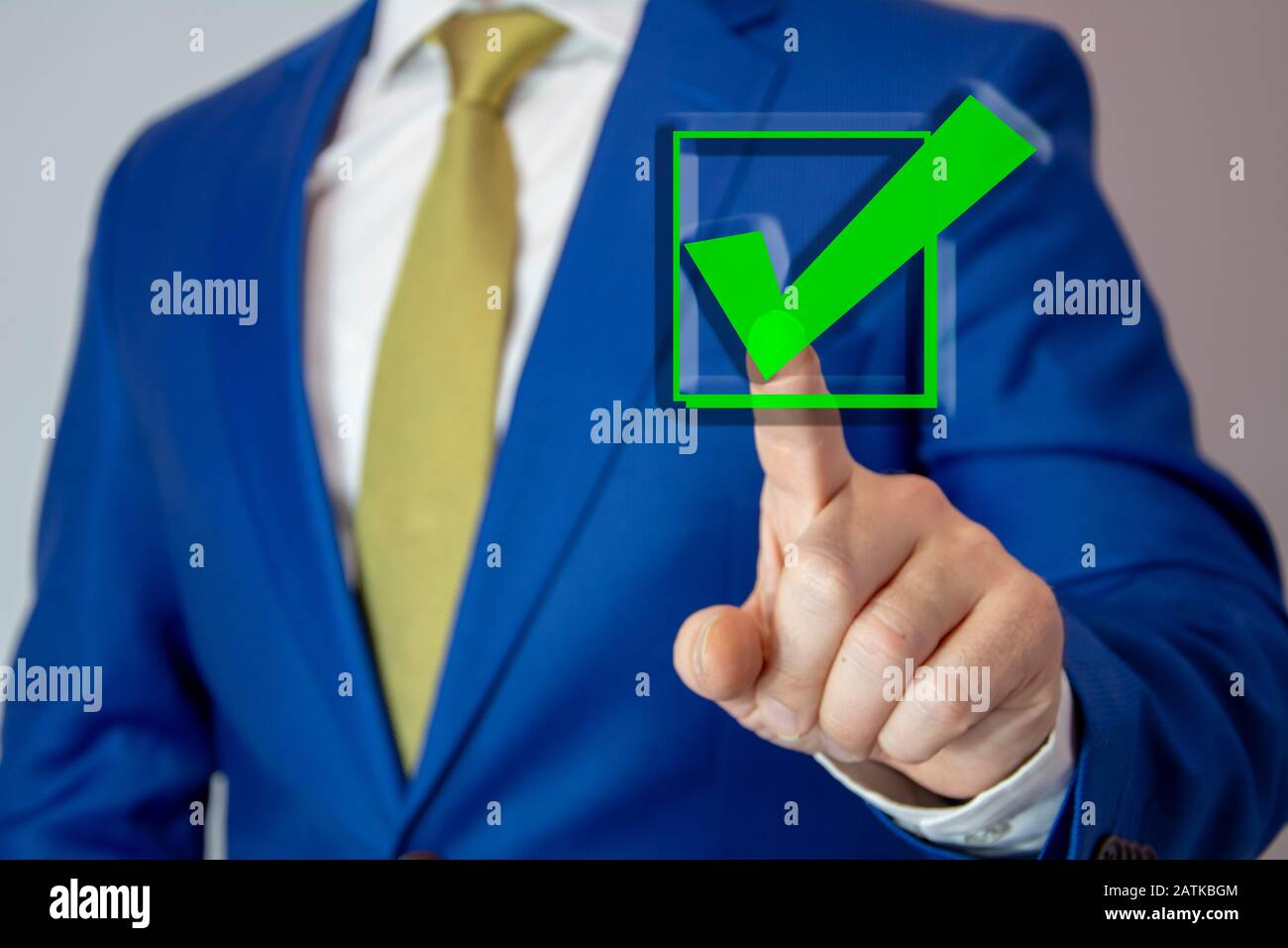 business man touching check mark on virtual screen with hand Stock Photo