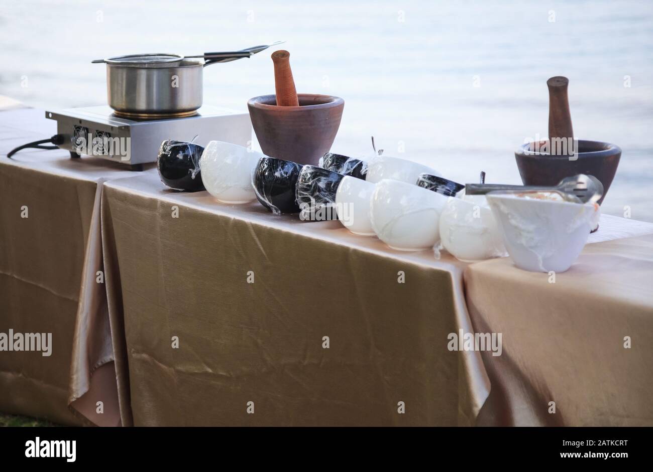 Stainless steel pot on gas fueled stove, mortars and ingredient bowls