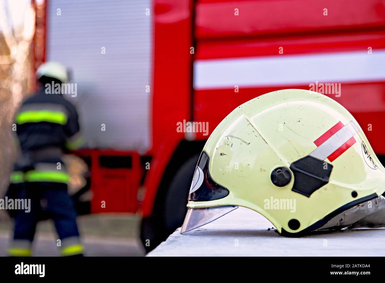 Fireman gear on fire truck. Firefighter helmet Stock Photo