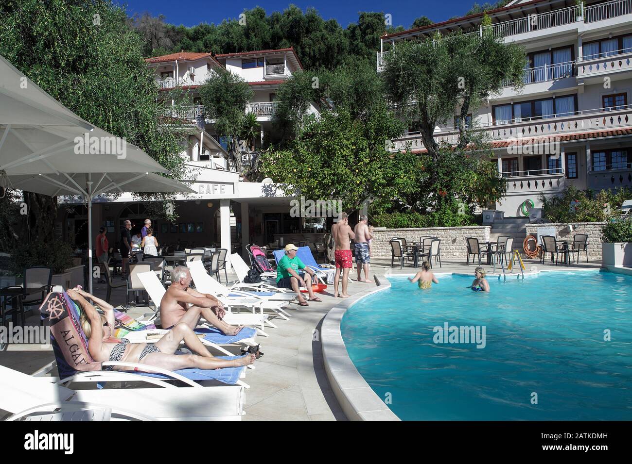 Holidaymakers at the Valtos Beach Hotel in Barga enjoying relaxing and swimming in the outdoor pool on glorious October day in north-west Greece. Stock Photo