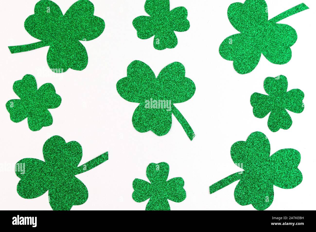 St.Patrick 's Day. Pattern of Clover shamrocks isolated on a white background. Glitter paper Stock Photo