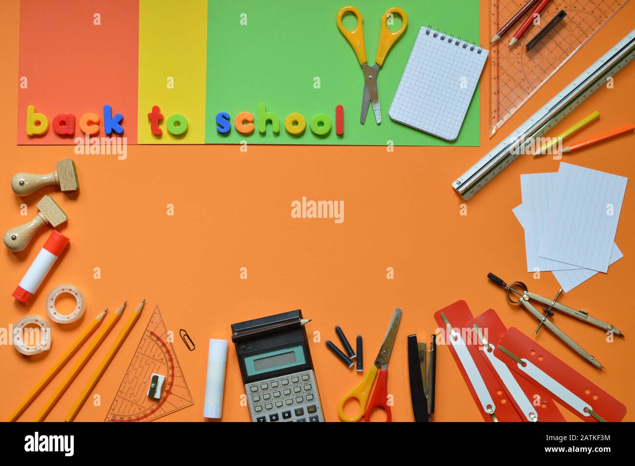 School supplies on colorful paperboard and the words BACK TO SCHOOL