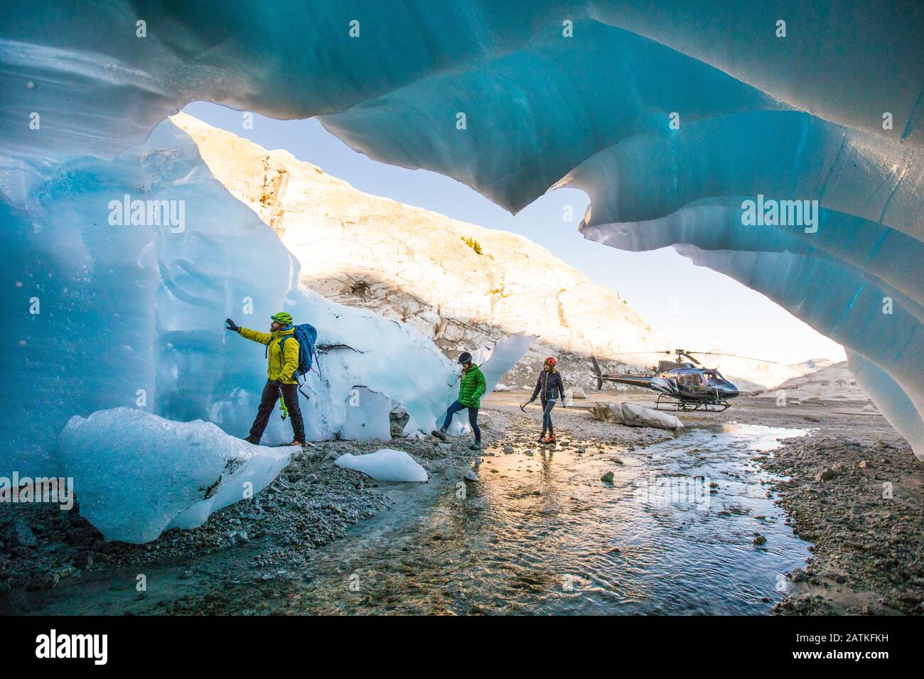 Explorers enter a glacial cave near Vancouver, B.C. Stock Photo