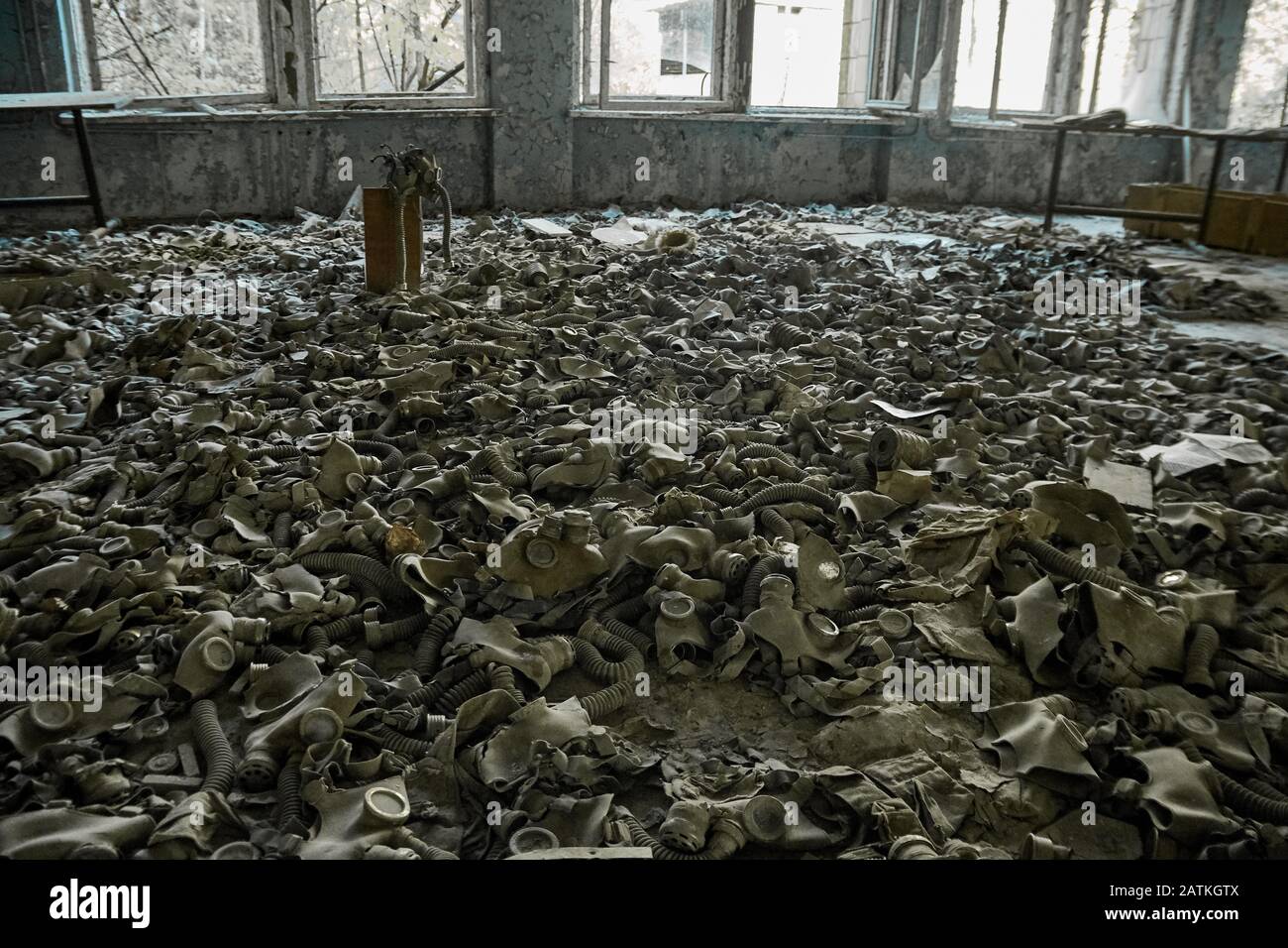 Gas masks on the floor with an old television in an abandoned middle school in Pripyat - Chernobyl nuclear power plant zone of alienation Stock Photo