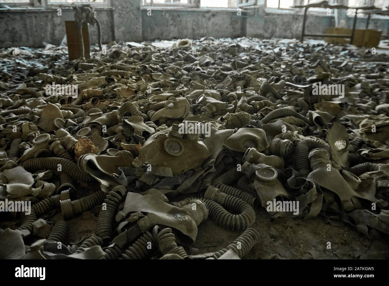 Gas masks on the floor with an old television in an abandoned middle school in Pripyat - Chernobyl nuclear power plant zone of alienation Stock Photo