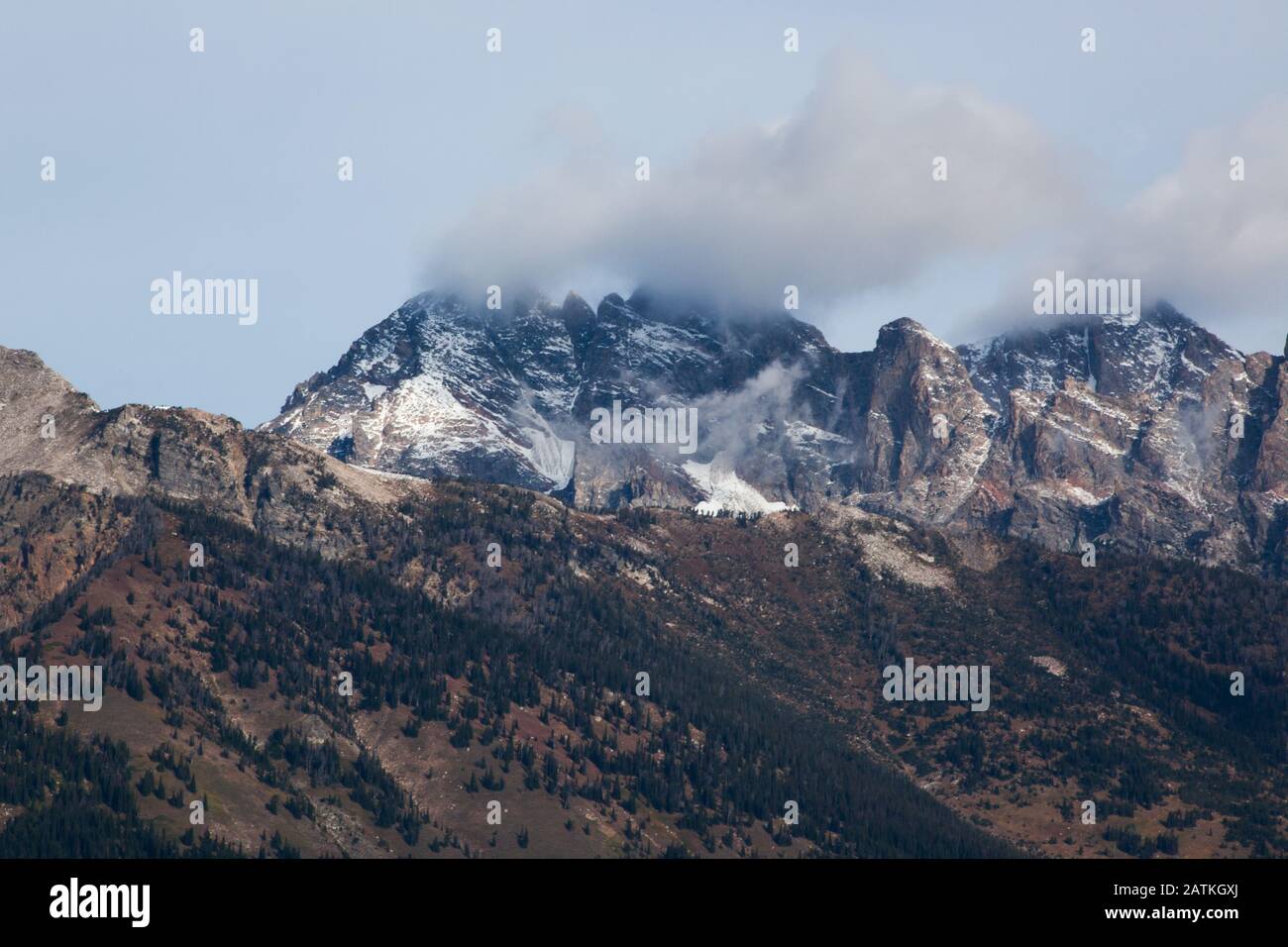 Snow Capped Mountain with clouds Stock Photo - Alamy