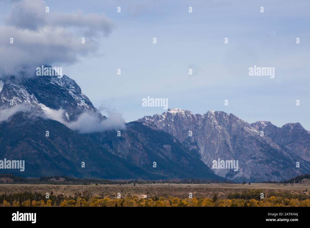 Snow Capped Mountain with clouds Stock Photo - Alamy