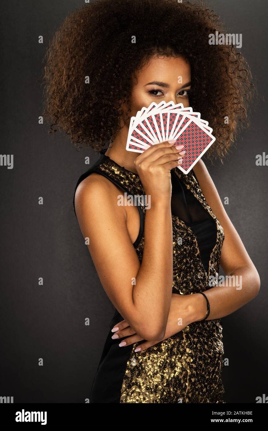 Young afro woman holding playing cards Stock Photo