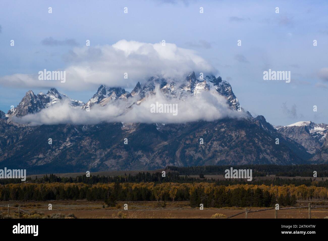 Snow Capped Mountain with clouds Stock Photo - Alamy
