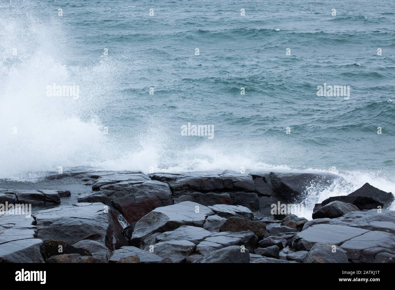 Waves against a Rocky shore Stock Photo - Alamy