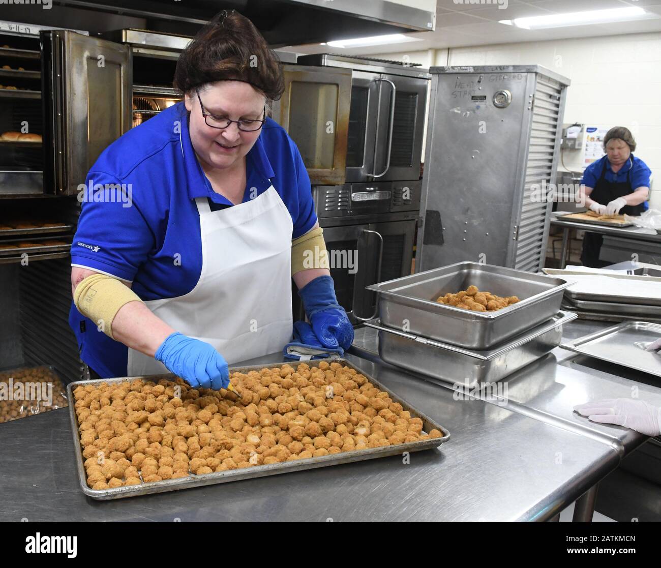 Racine, Wisconsin, USA. 3rd Feb, 2020. School lunches are prepared at Gifford (K-8) School in Racine, Wisconsin Monday February 3, 2020.SHERI BENISH checks the temperature of popcorn chicken balls she just took out of the oven. The Trump Administration has proposed relaxing some of the nutrition standards adopted for school lunches during the Obama Administration. Some school lunch officials have welcome the changes because they say by making the meals more palatable and like what students eat at home, students will be more inclined to eat a full lunch, and there will be less wasted food. Stock Photo