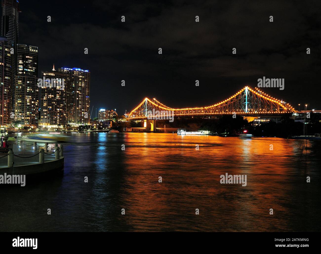 View From City Reach Boardwalk The Brightly Illuminated Story Bridge In Brisbane At Night Queensland Australia Stock Photo