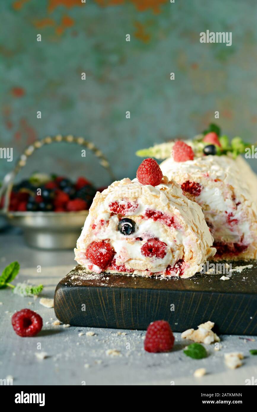 Meringue roll with a gentle airy cream, mint and fruit filling from  raspberries, black currants, blueberries. Pavlova summer sweet dessert  Stock Photo - Alamy