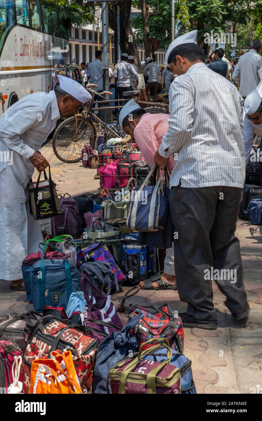 India, Mumbai aka Bombay. Dabbawalas (aka dabbawallas or dabbawallahs, tiffin wallahs) deliver lunches all over the city every day. Stock Photo