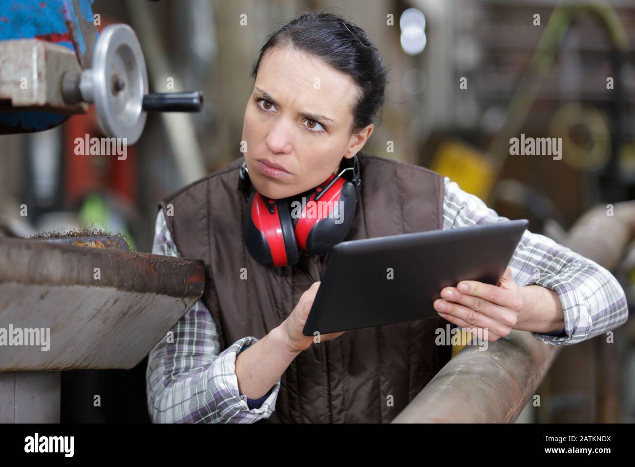 female technician taking notes with help of digital tablet Stock Photo