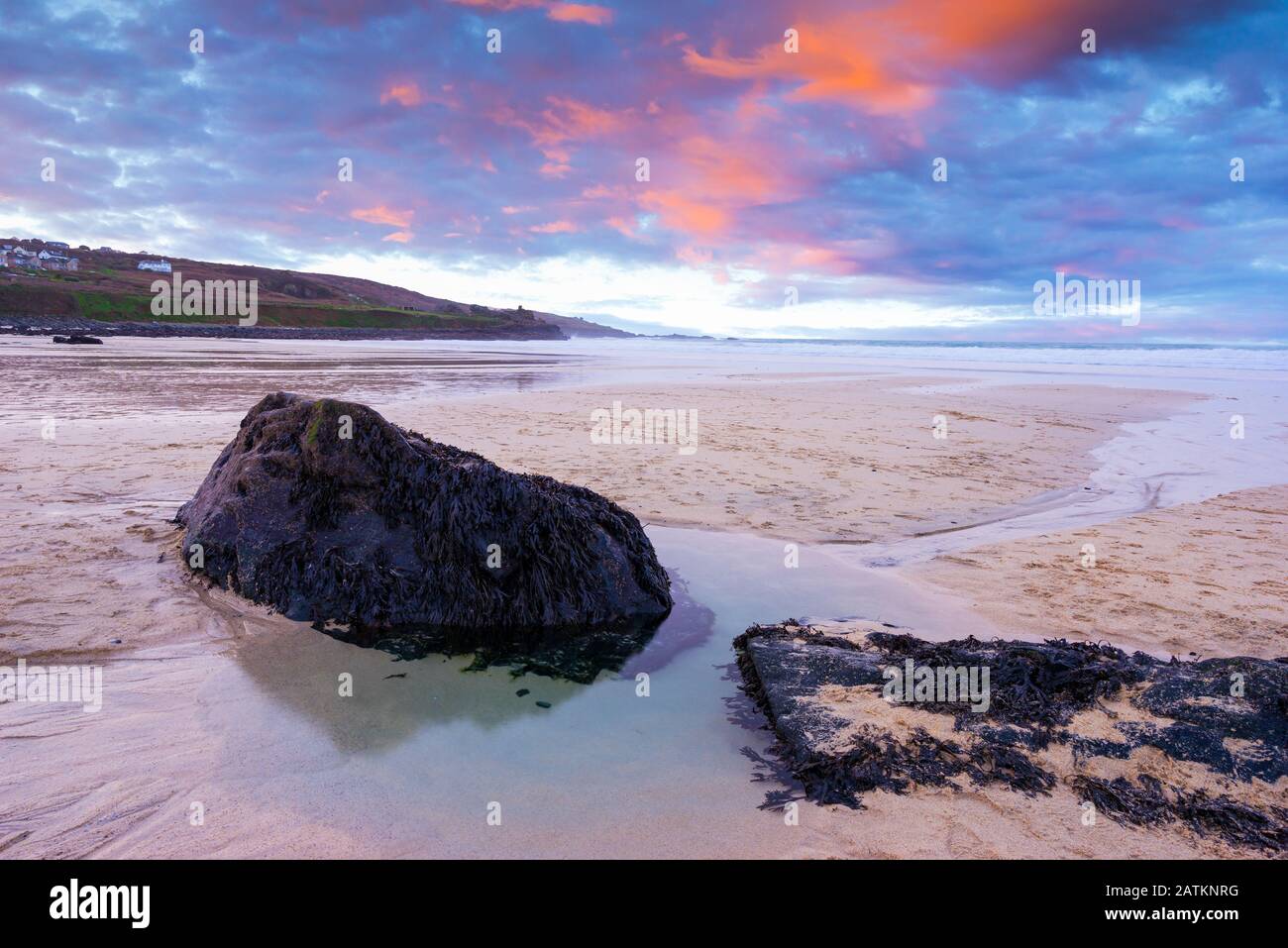 Vibrant sunset on the golden sand at Porthmeor Beach St Ives Cornwall England UK Europe Stock Photo