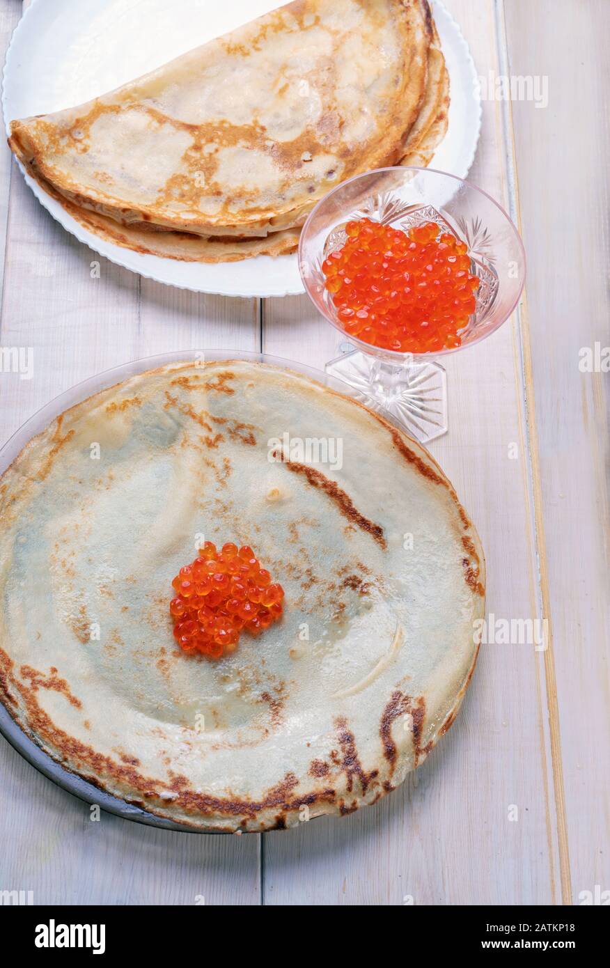 Pancakes with fish roe   of chum salmon  as filling - on white surface Stock Photo