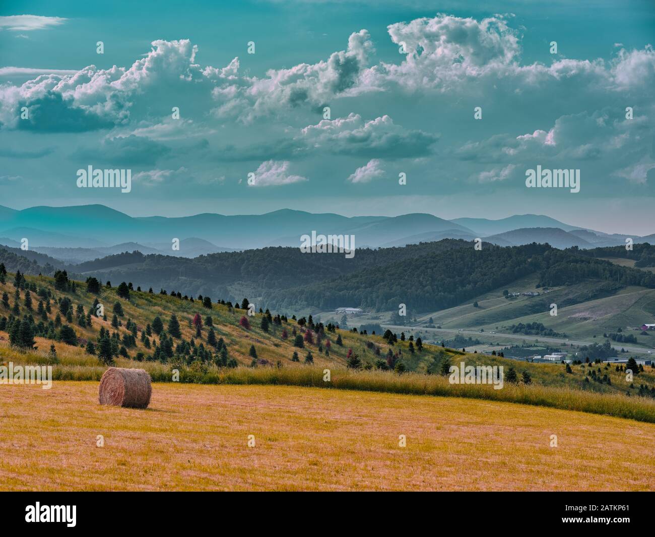 Teal Clouds over mountains by a field on a beautiful day at Blue Ridge Parkway, North Carolina Stock Photo